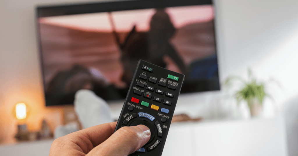 a hand holding a remote control a hand holding a remote control